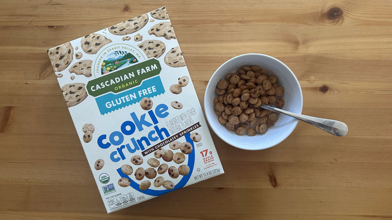 Cascadian Farm Cookie Crunch Cereal in a white bowl on table with the box on the side