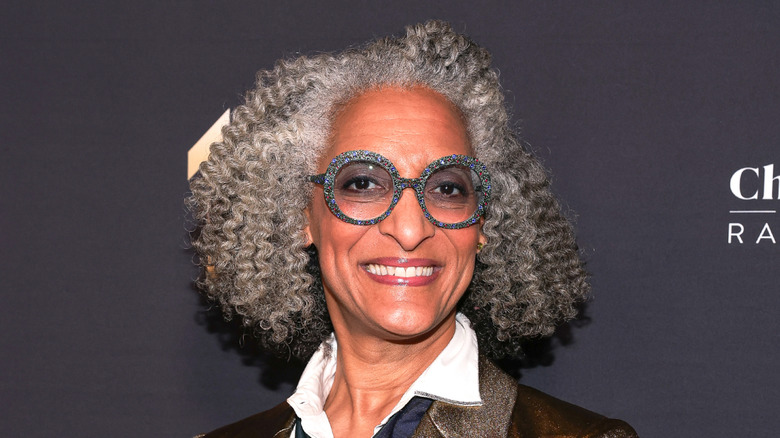 Carla Hall smiling on a red carpet