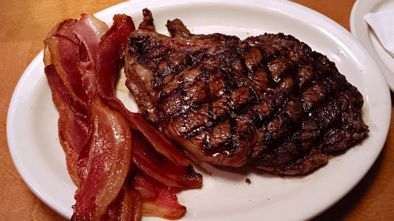 16-ounce grilled ft worth ribeye with bacon on white plate