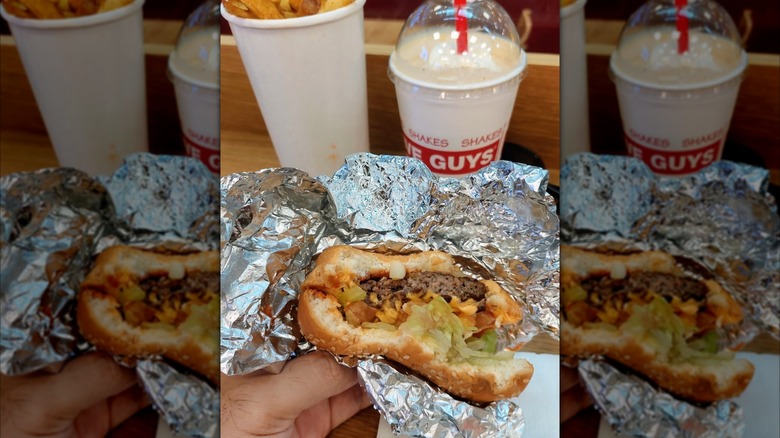 Mirrored image of Five Guys food with half eaten burger