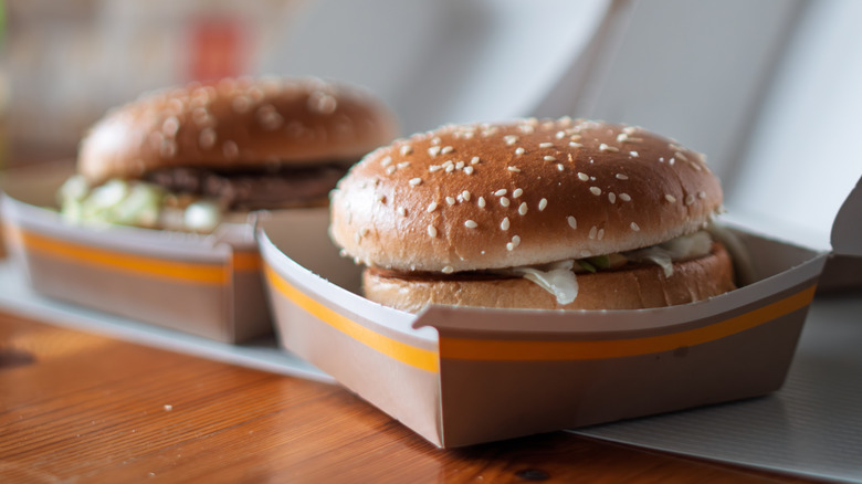 fast food burgers in takeout boxes
