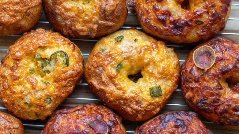 Various savory bagels on cooling rack