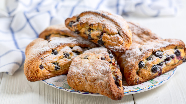 Berry scones with powdered sugar on plate