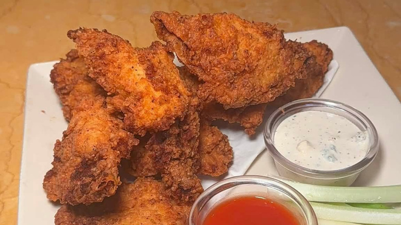 Cheesecake Factory Buffalo Blasts with sauces on a white plate