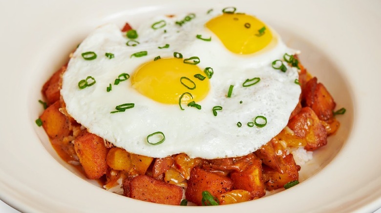 Jambalaya Hash & Eggs dish with two fried eggs