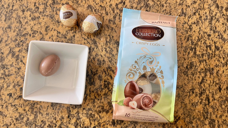 Ferrero Hazelnut Eggs on the countertop with one egg inside a dish next to a packaging