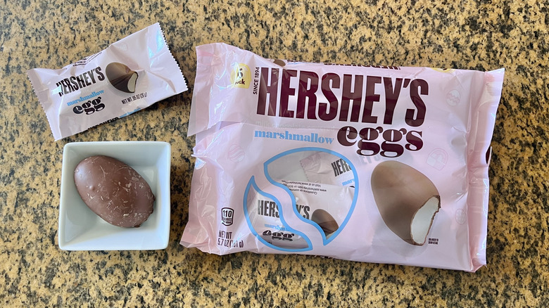 Hershey's Milk Chocolate Marshmallow Eggs wrapper on countertop with one mini wrapper outside and one unwrapped egg in a dish