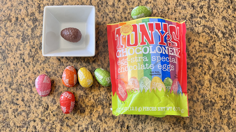 Tony's Chocolonely Easter Chocolate Egg Pouch in a dish with some on the counter next to the package