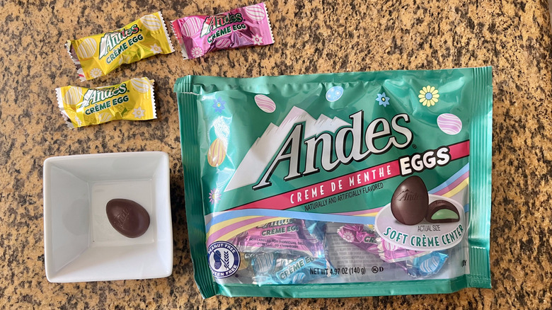 Andes Crème De Menthe Chocolate Eggs on countertop with one unwrapped egg inside a bowl