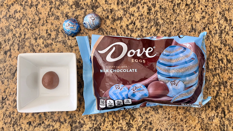 Dove Milk Chocolate Easter Eggs on a counter with a wrapper and one unwrapped egg in a dish