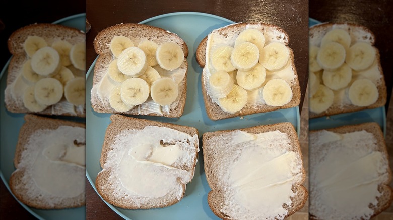Open banana and mayonnaise sandwiches on a blue plate on a wooden table