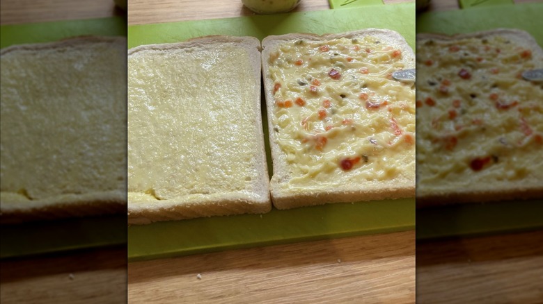 Open sandwich spread sandwich on a green chopping board