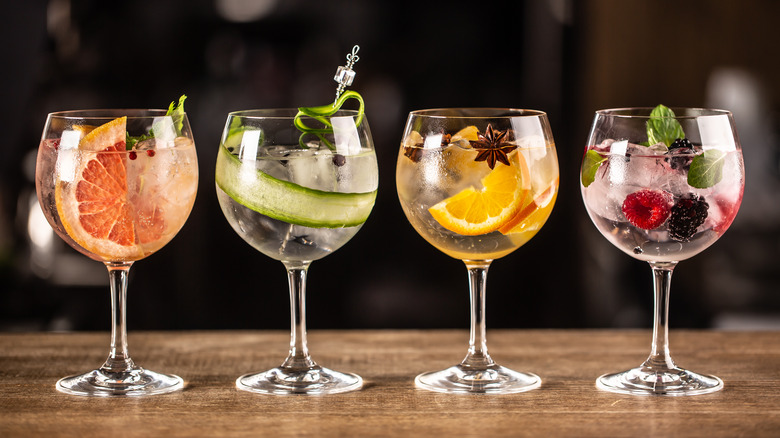 Gin tonic long drink as a classic cocktail in various forms with garnish in individual glasses such as orange, grapefruit, cucumber or berries.