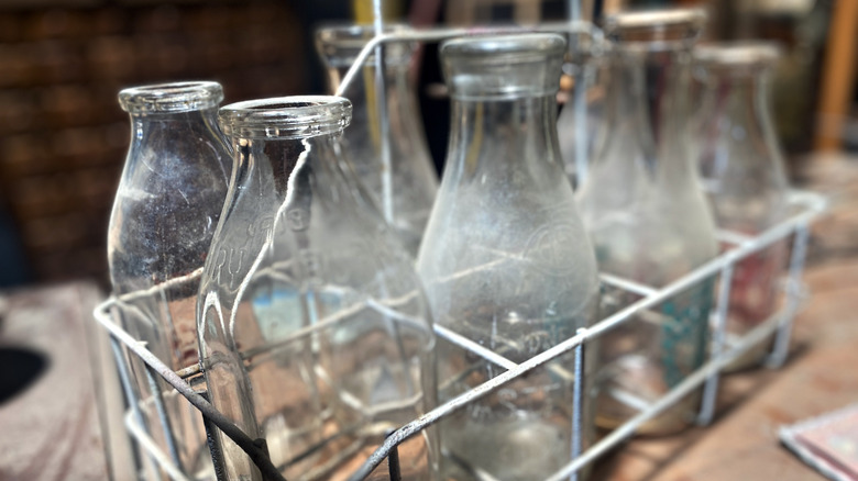 Glass milk bottles in metal tray