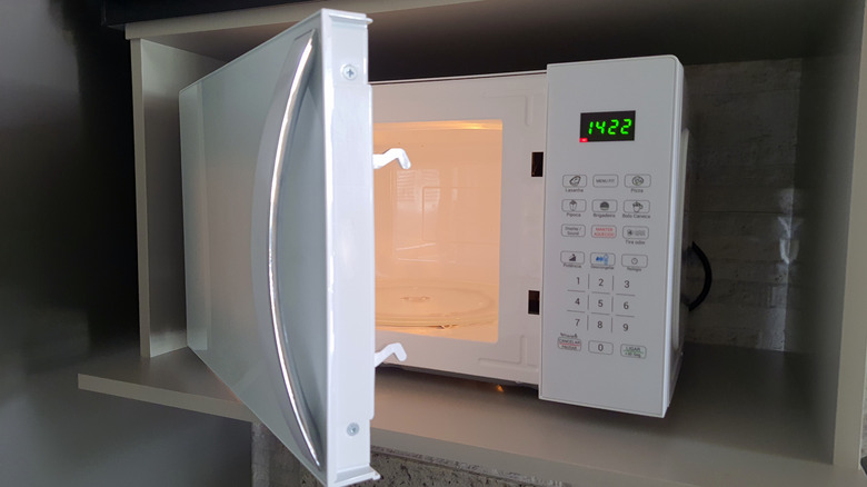 Open white microwave with light on
