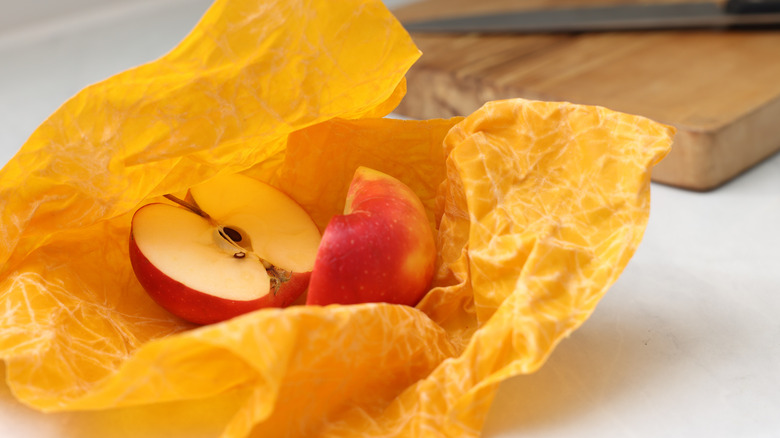 Cut apple in yellow beeswax food wrap