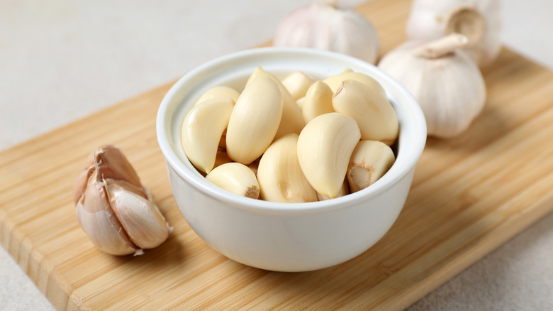 Garlic cloves in small white bowl
