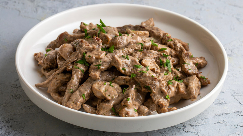 white bowl of stroganoff with mushrooms