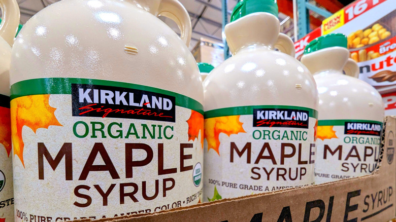 Three jugs of maple syrup on Costco shelf