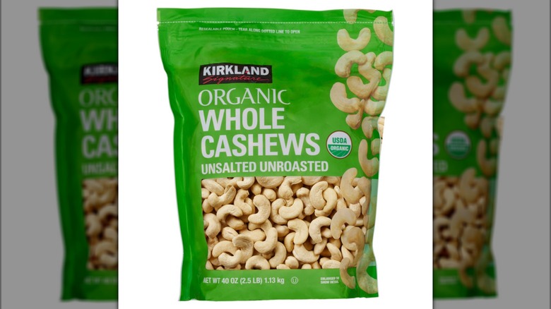Plastic container of cashews in Costco shopping cart