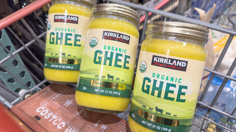 Three glass jars of ghee in Costco shopping cart