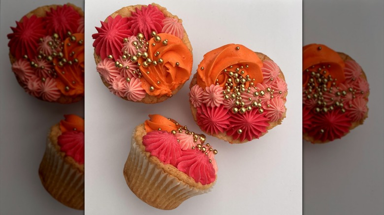 cupcakes decorated with frosting in various piping designs