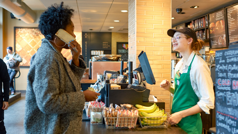 Starbucks barista talking with customer