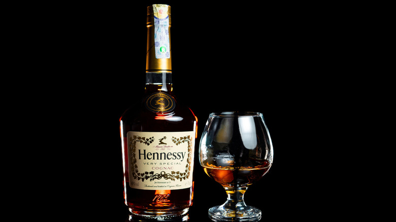 The bottle of Hennessy very special cognac on the black background