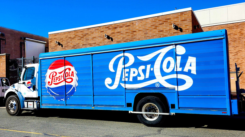 Side view of a delivery truck with an old school Pepsi Cola logo.