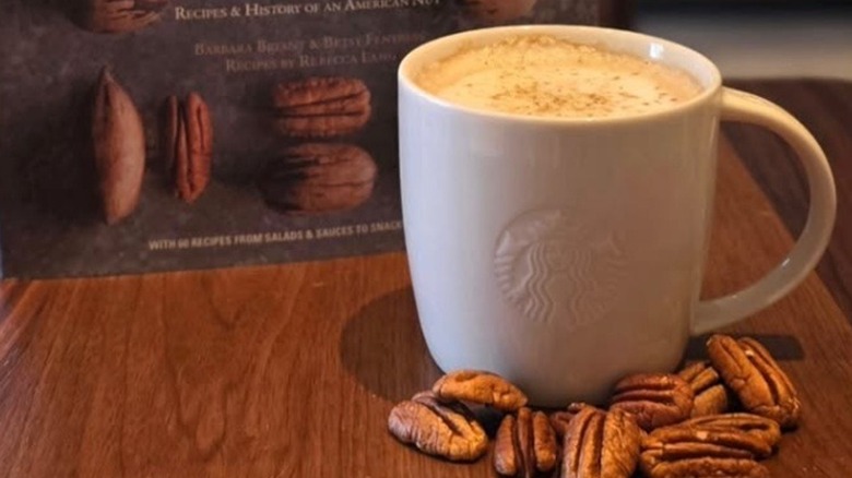 pecan cortado in china mug with pecans on table from Starbucks