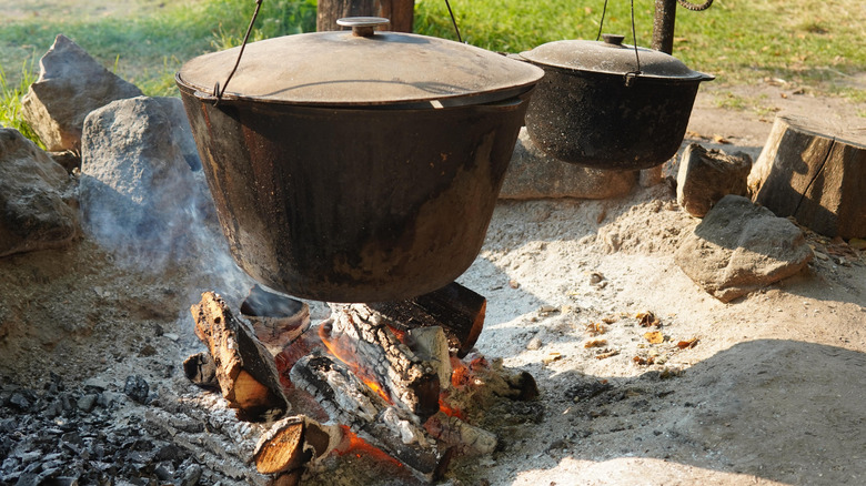 Pot of stew cooking over an open fire