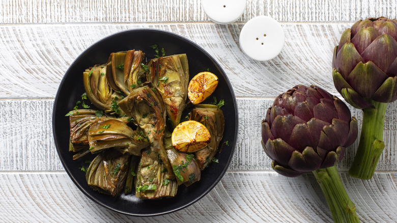 overhead view of cooked and raw artichokes