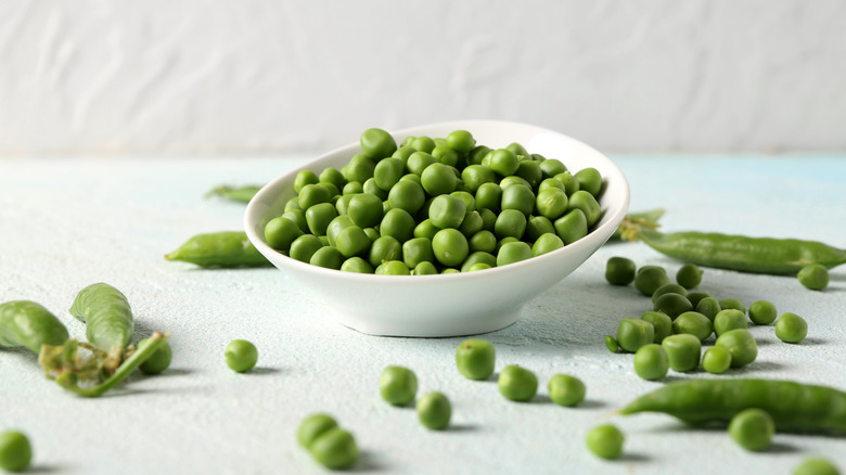 fresh green peas in white bowl