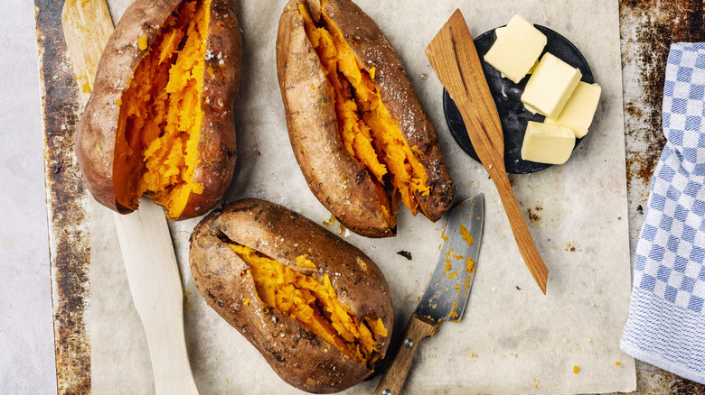 overhead view of baked sweet potatoes and butter