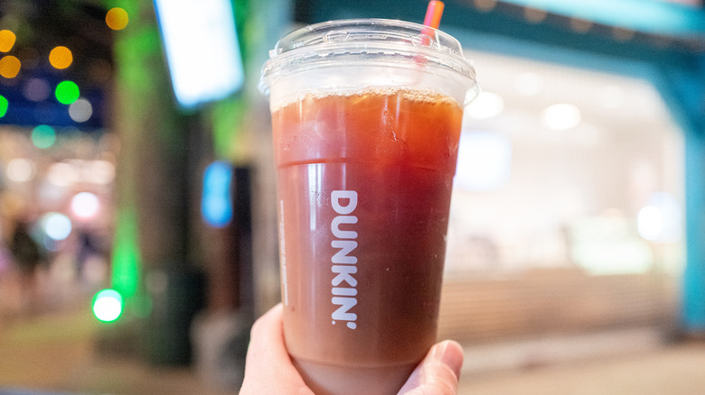 Hand holding iced Dunkin' coffee