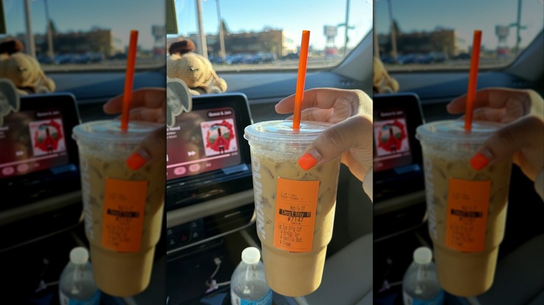 Hand holding iced Dunkin' coffee