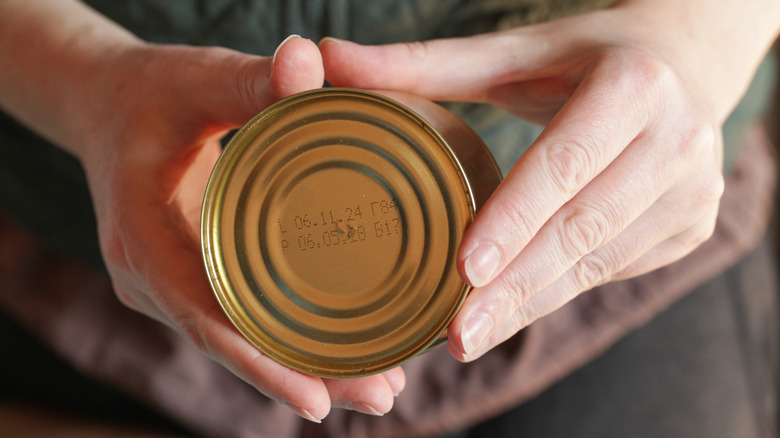 Close-up of hand holding can