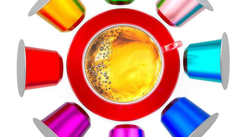 Colorful coffee pods surrounding a coffee cup