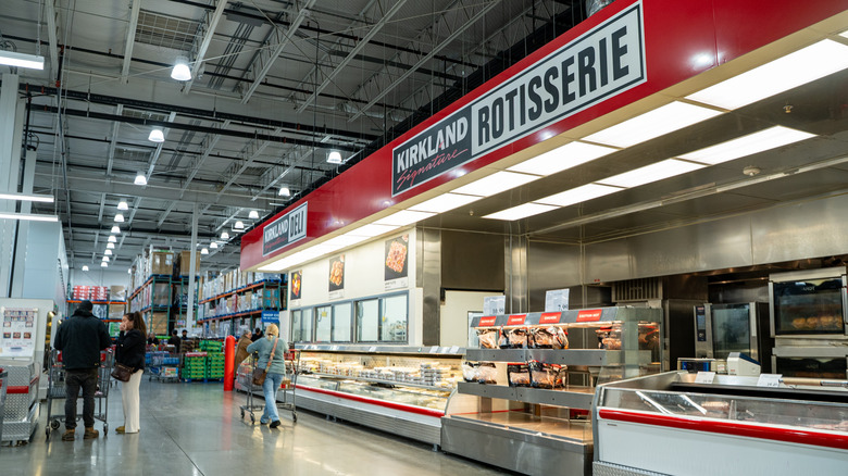Interior of a Costco deli section near rotisserie chicken display