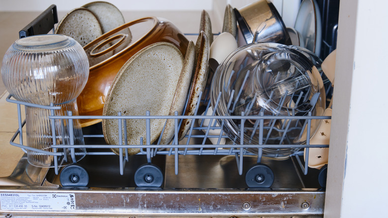 Dishes including a glass bowl in the bottom rack of a dishwasher