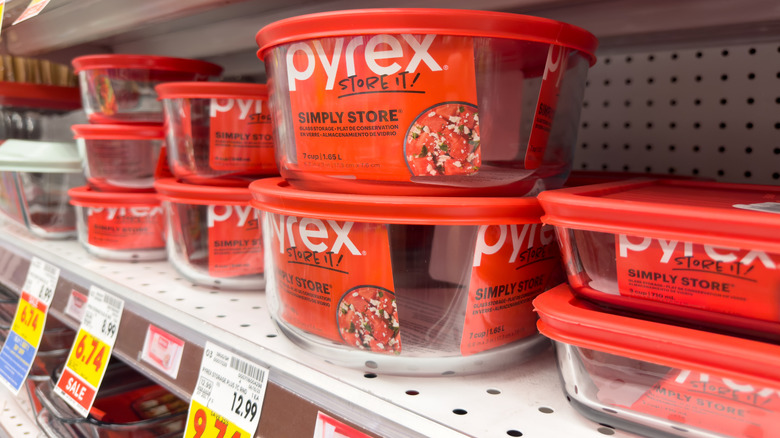 Glass Pyrex dishes with red lids on store shelf