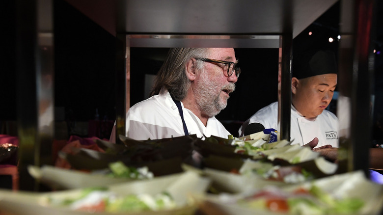 Joachim Splichal, Chef and Founder, Patina Restaurant Group, prepares food behind pass