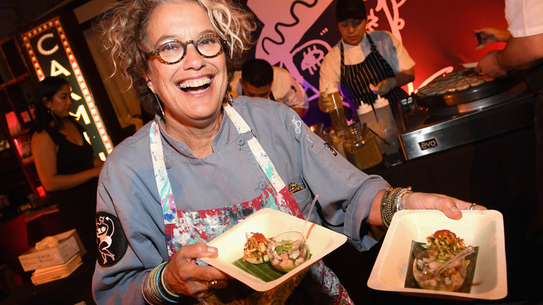 Border Grill co-owner and chef Susan Feniger smiling and serving food