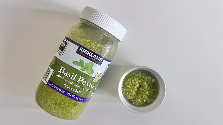 Kirkland Signature Genovese pesto with some scooped in a dish