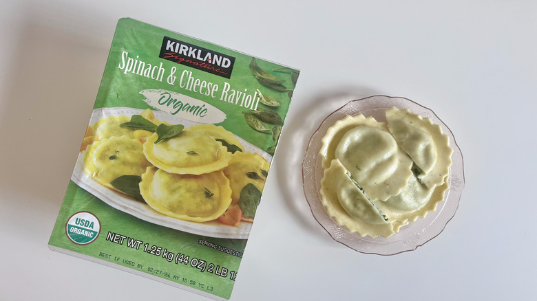 Kirkland Signature spinach and cheese ravioli pieces displayed on a plate with a whole package next to it
