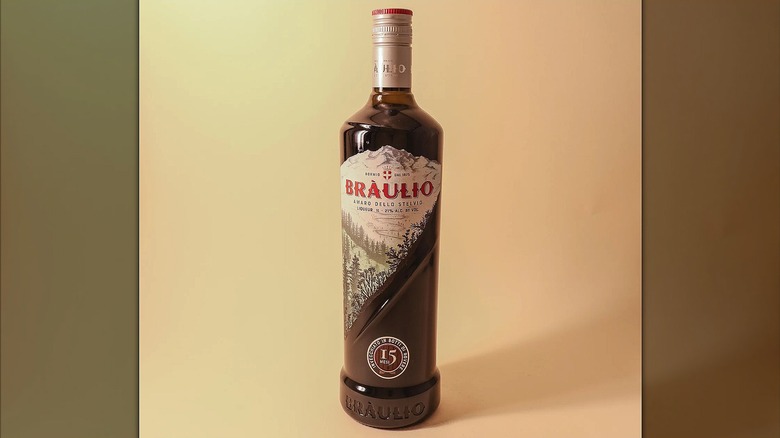 A bottle of Braulio against beige background.