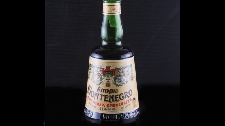 Bottle of Amaro Montenegro against black background.
