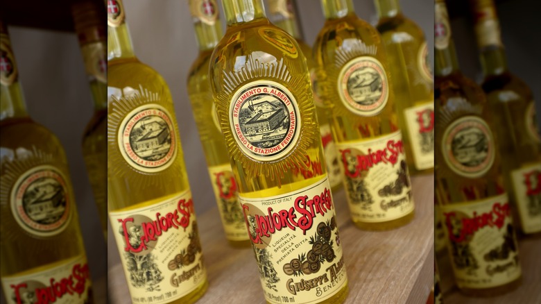 Bottles of Strega on a shelf.