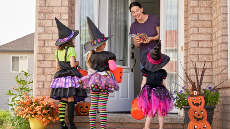 Woman handing out Halloween candy