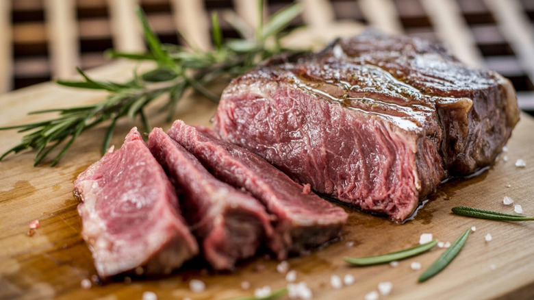 Sliced rare steak on a cutting board